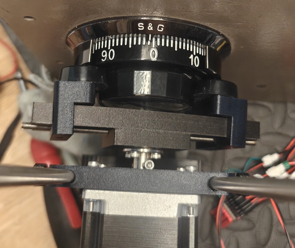 Close-up of the LockManipulator self-centering 3D-printed gripper clamped around an S&G safe dial