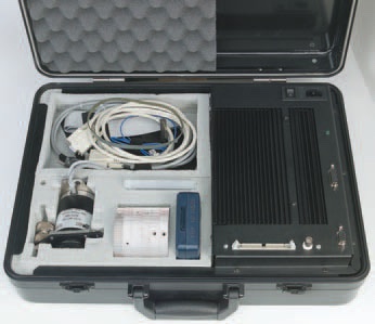 SoftDrill kit in its briefcase: control unit with heat sink, stepper motor, dial pulley, cables and PCMCIA data acquisition card