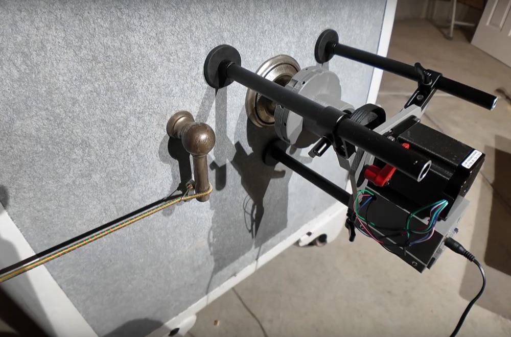 Startup Chuck autodialer on magnetic feet over a safe dial, with a cord attached to the safe handle